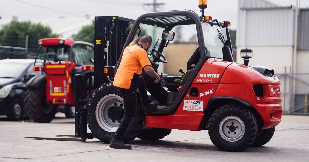 man getting into a forklift